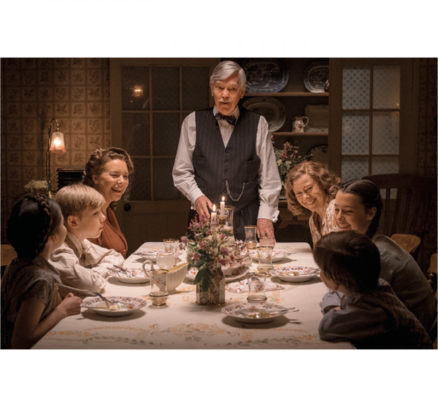 cast in a scene around the dinner table