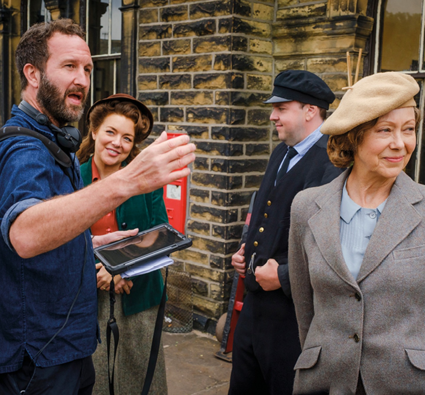 3 cast members chasing with director on set