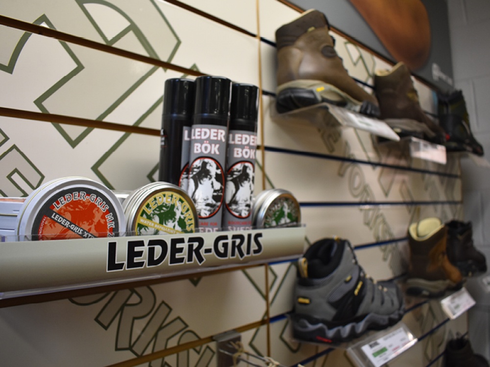 boot care products and boots lined up for sale