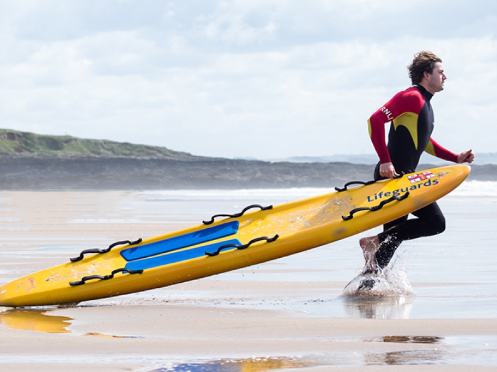 RNLI team member running into the sea
