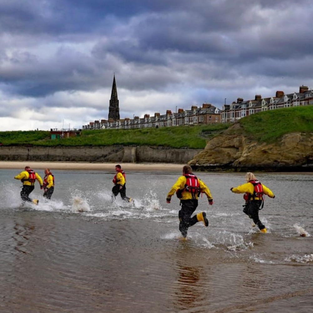 RNLI team running into water