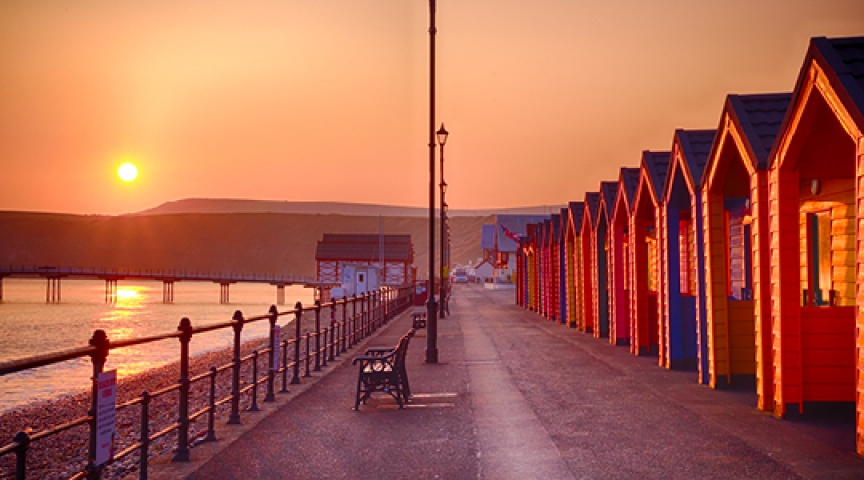 beach huts in sunset