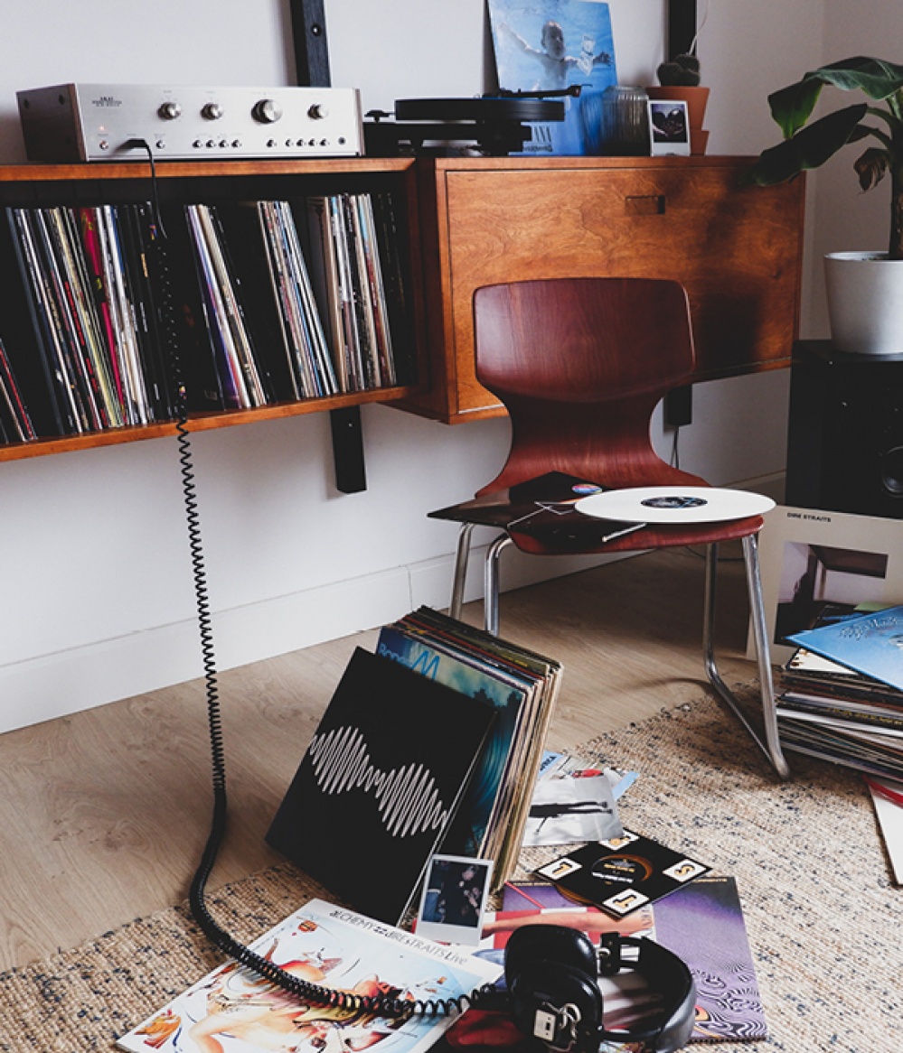 record playing with records in living space