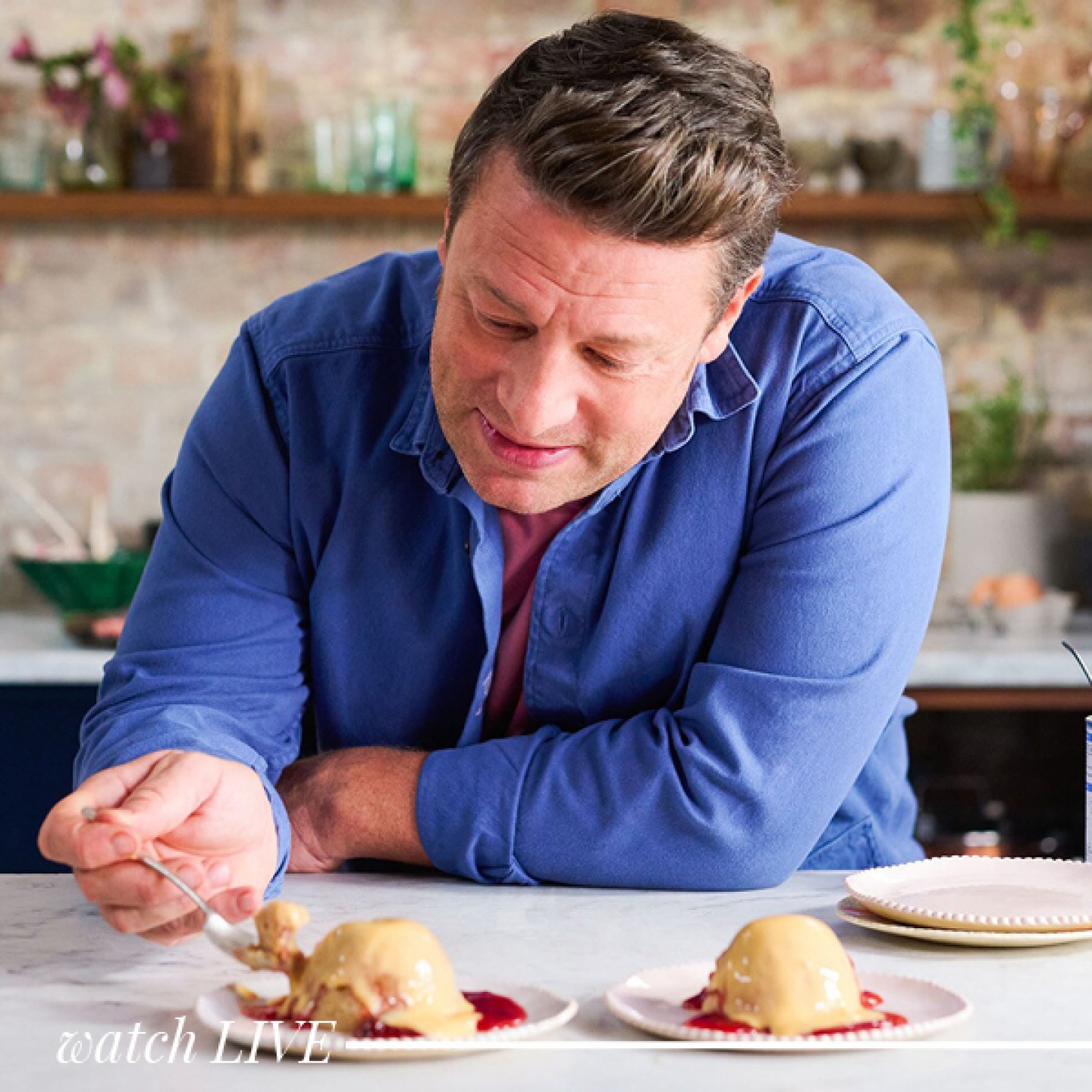 a man in a blue shirt eating a dessert