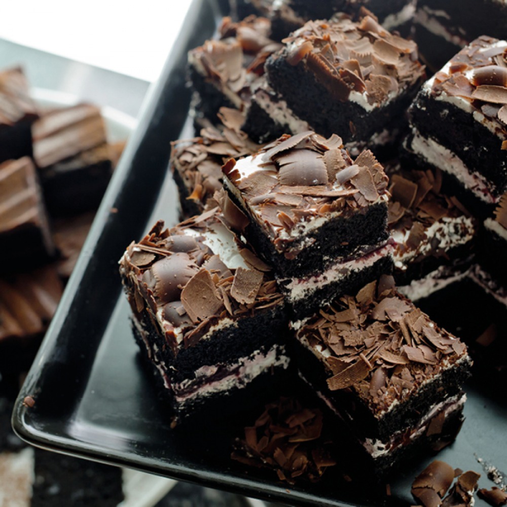 chocolate brownies stacked on a tray