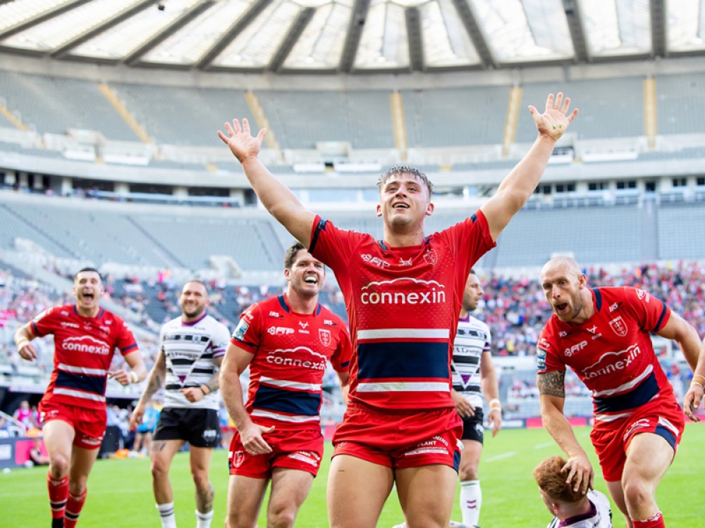 rugby players celebrating on the pitch after a try