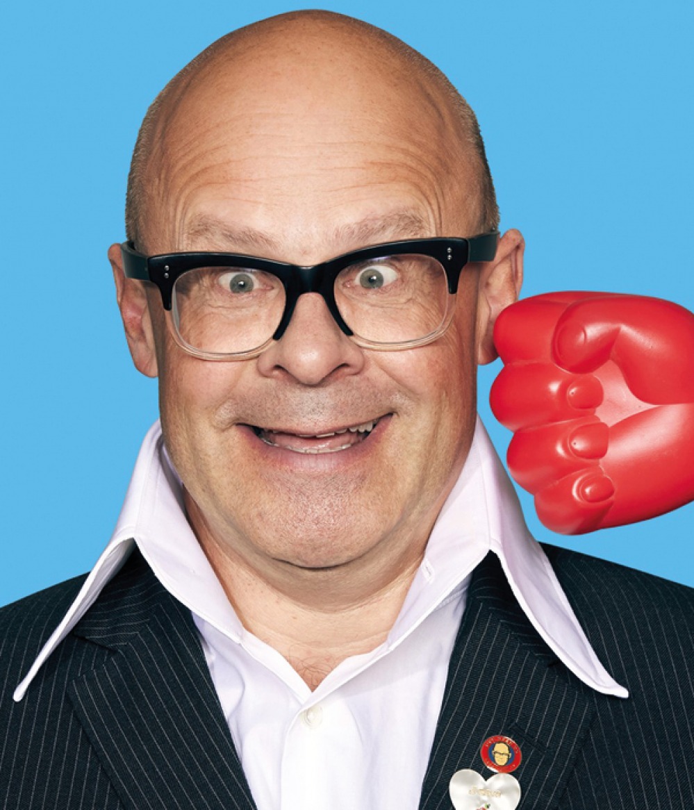 Harry Hill posing with red punching hand