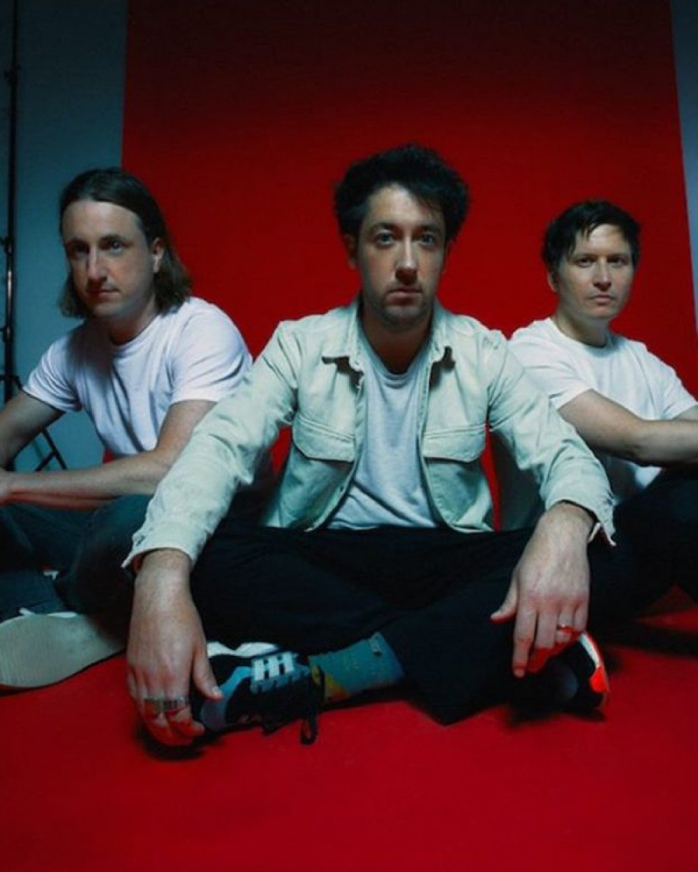 The Wombats sitting on red carpet