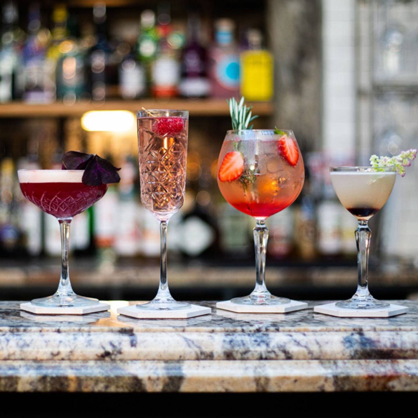 2 different cocktails on a marble table