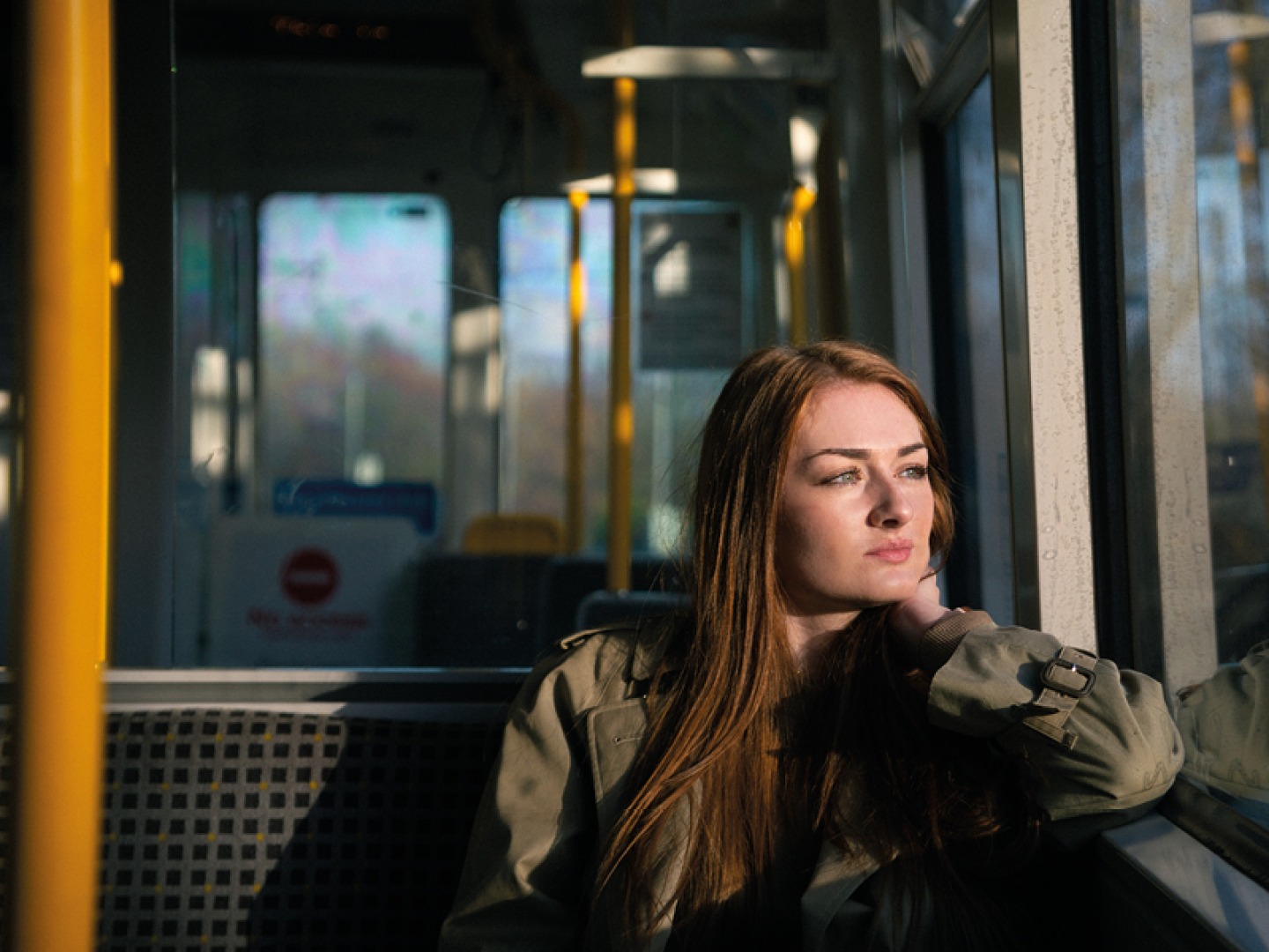 Woman looking out a train window