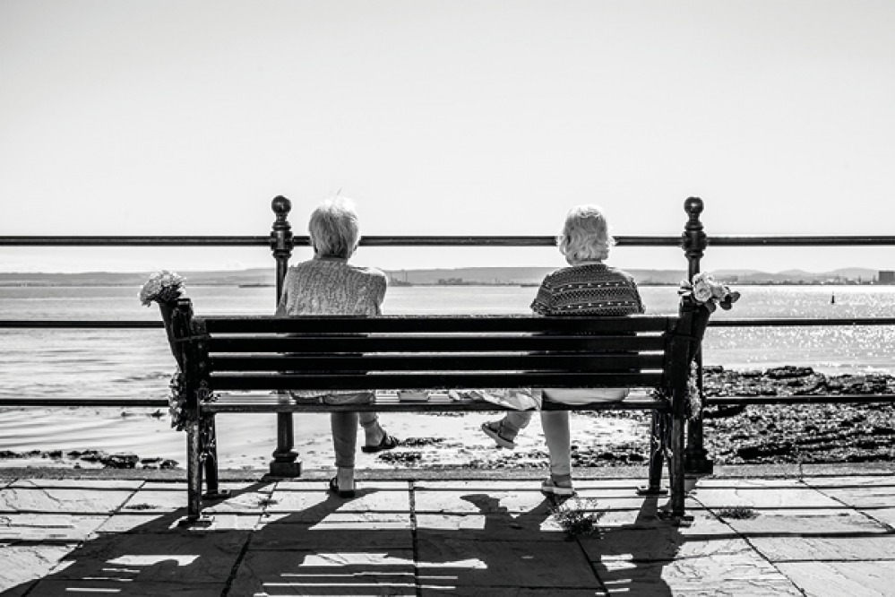 two friends looking out to sea