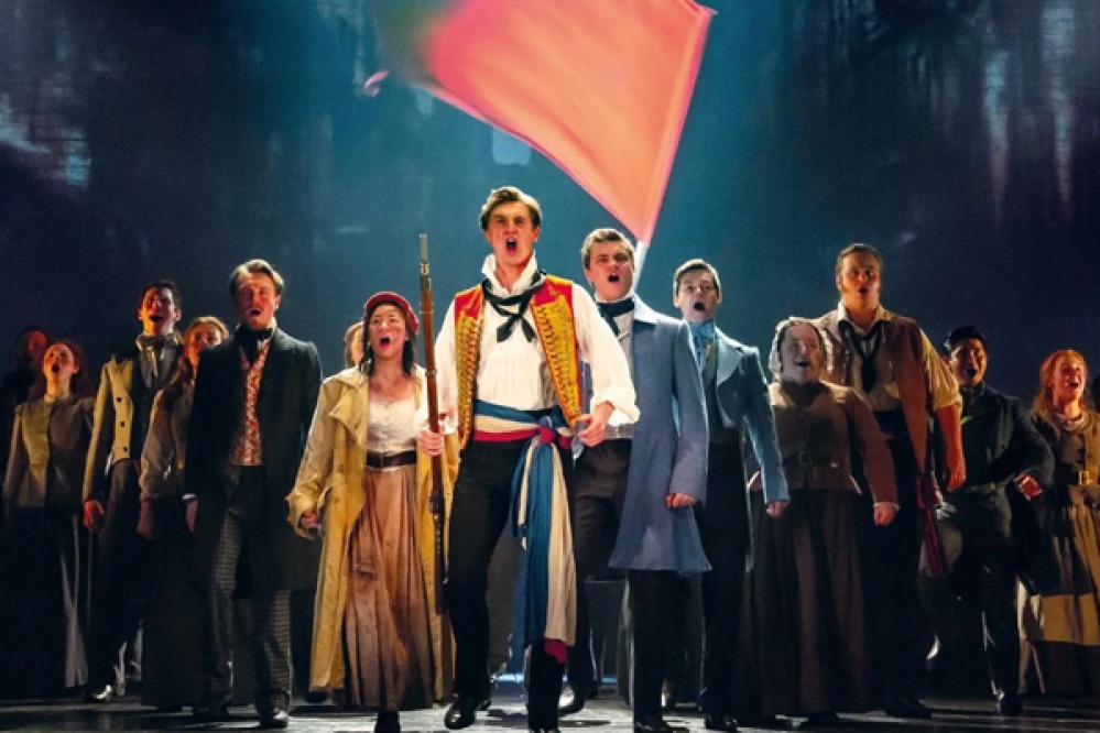 Actors singing on stage
