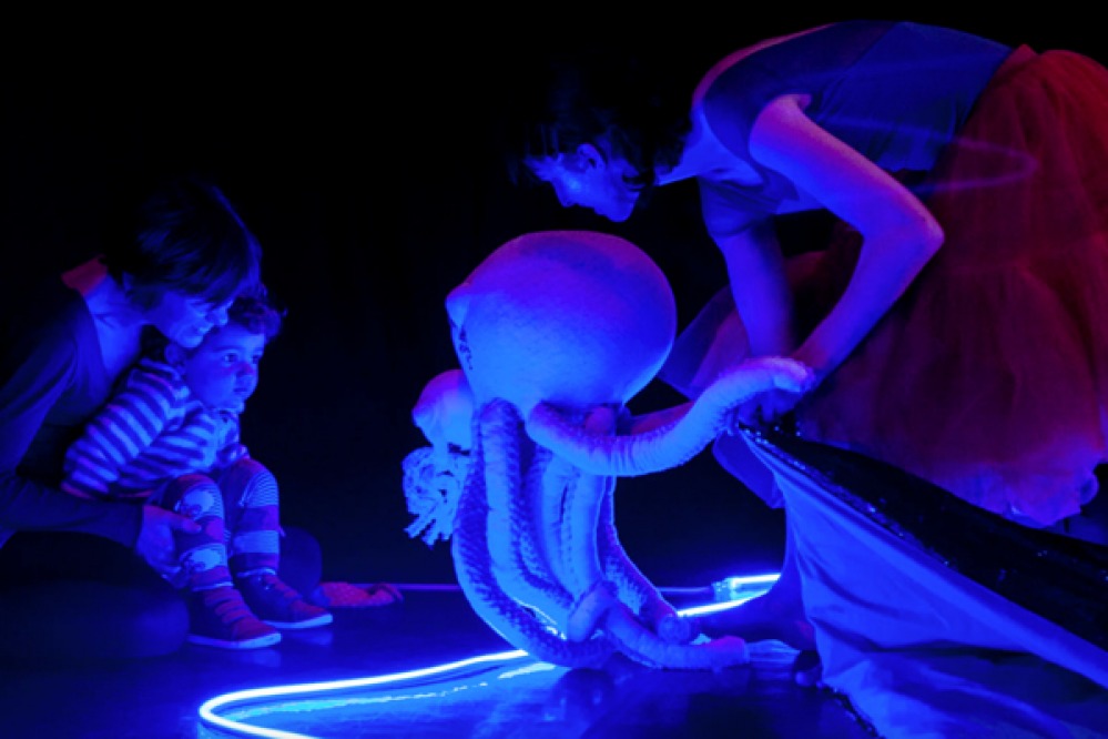 baby and mother enjoying a underwater light show