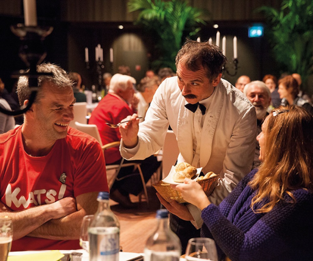 people being served at the table in a comedy show