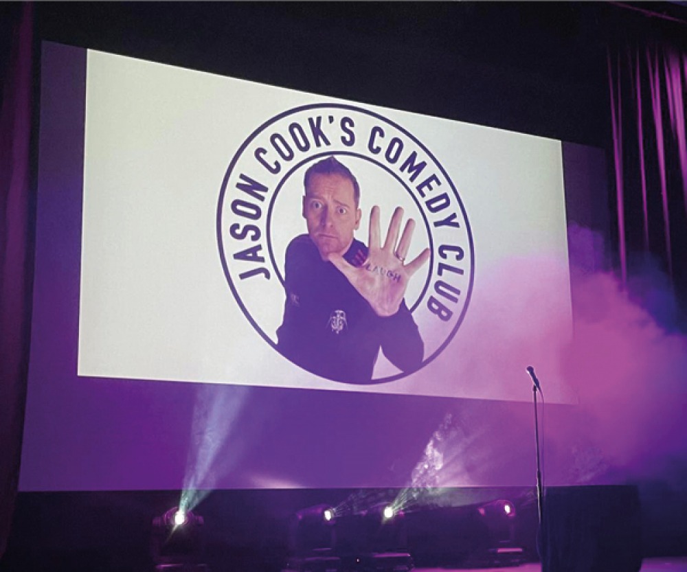 Projector screen with an image of Jason Cook