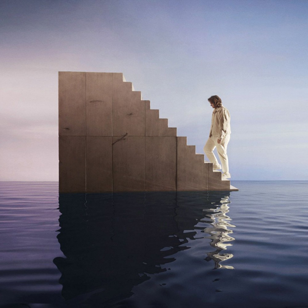 LEWIS CAPALDI walking up a floating staircase