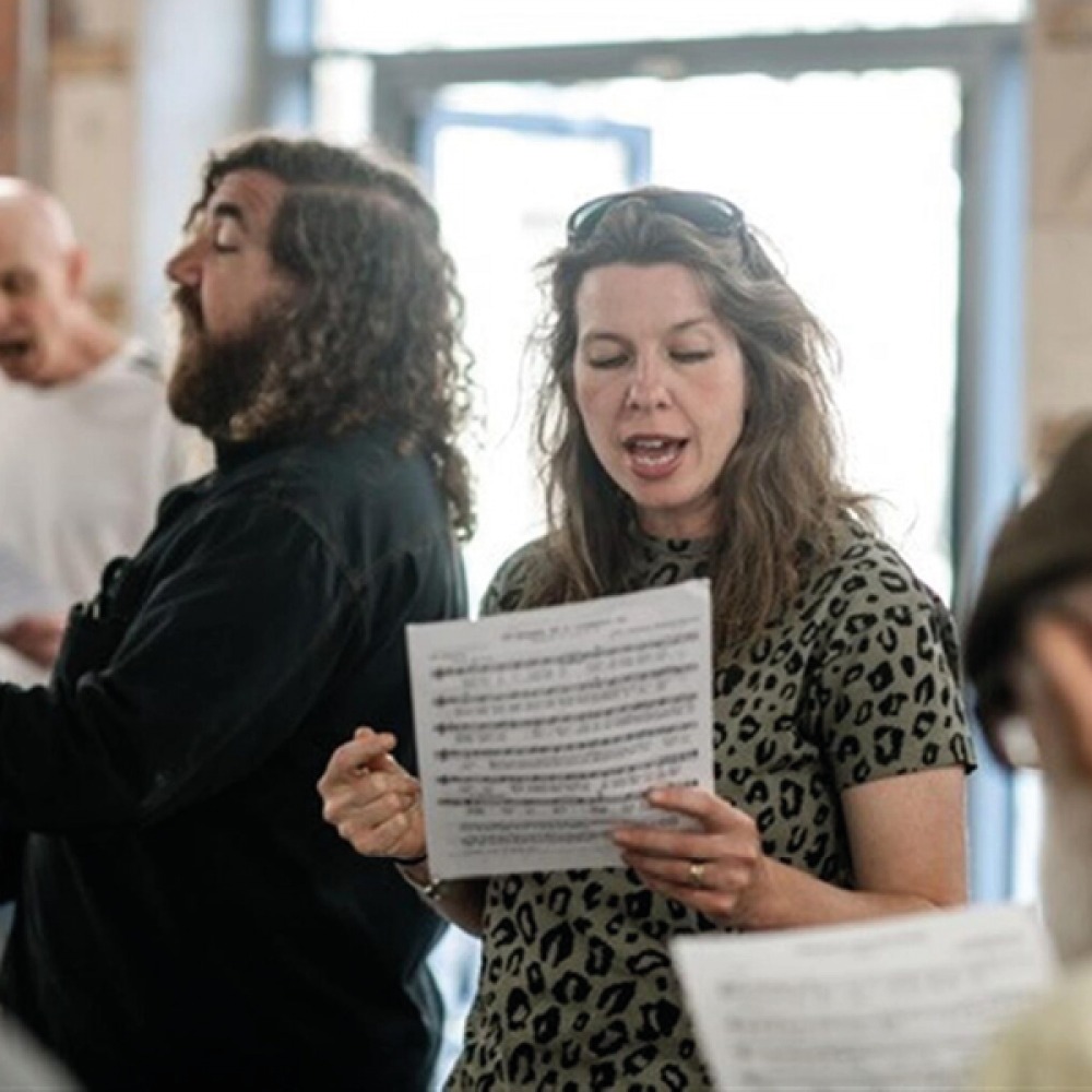people signing off music sheets