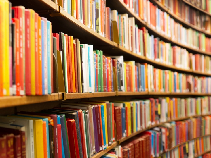 Rows of books on curved shelves