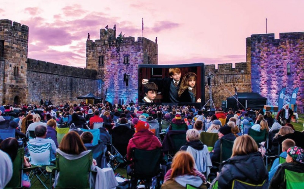 People watching Harry Potter on the big screen at Alnwick Castle