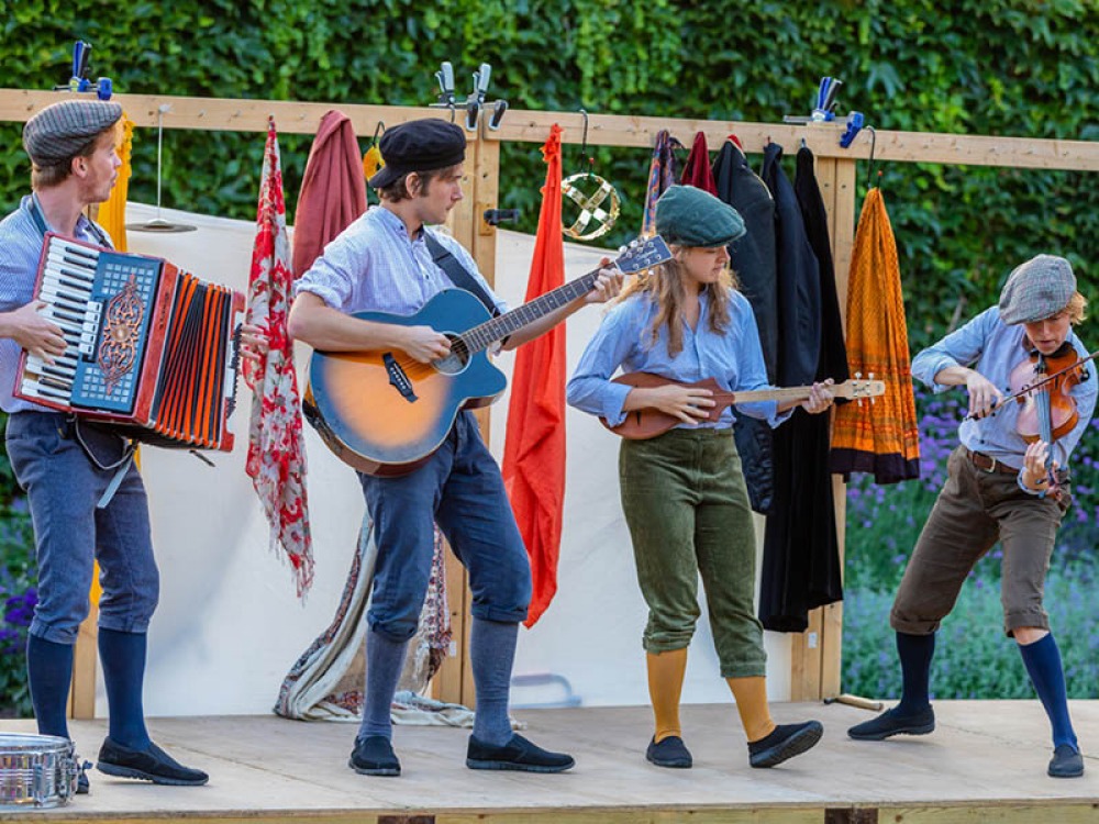 Folk Performers on stage playing instruments