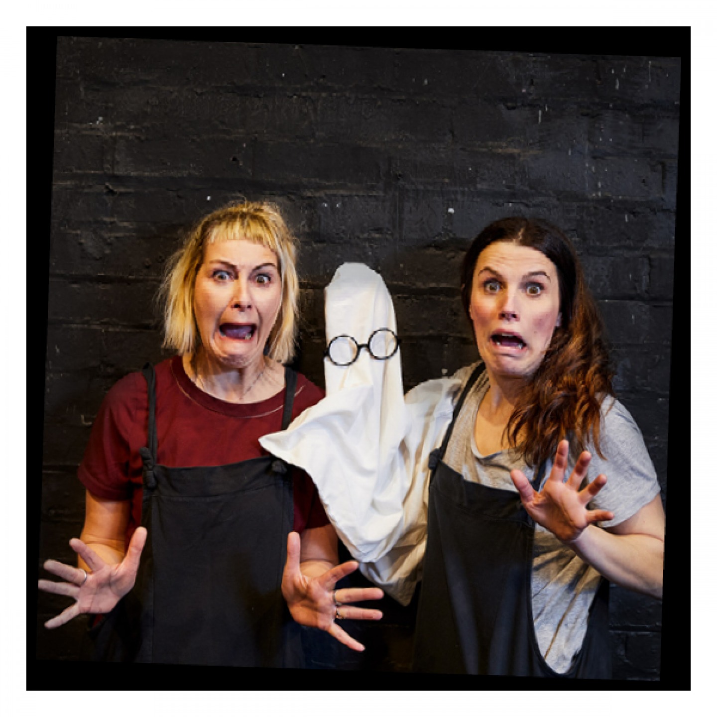 2 women holding a ghost puppet making scream faces