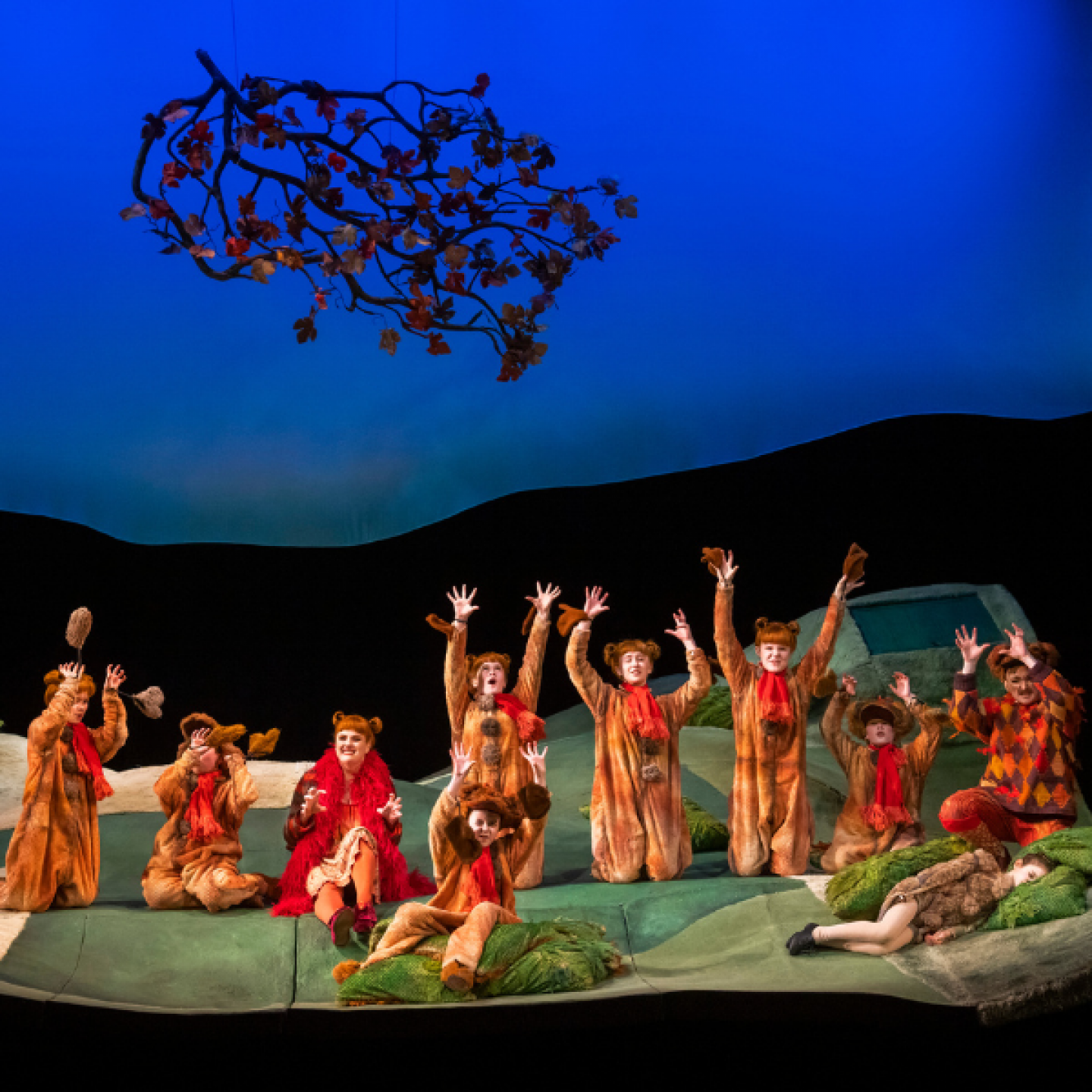 Heather Lowe as Fox and Elin Pritchard as Vixen Sharp-Ears with the children of The Cunning Little Vixen Company as Fox Cubs