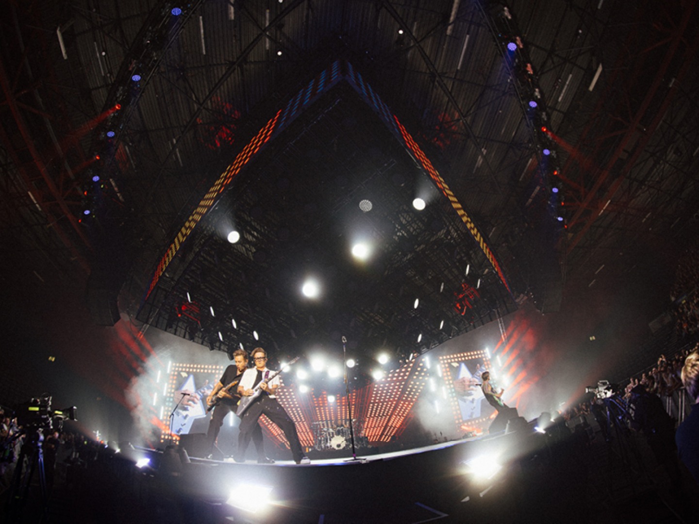 Mcfly on stage playing to stadium crowd
