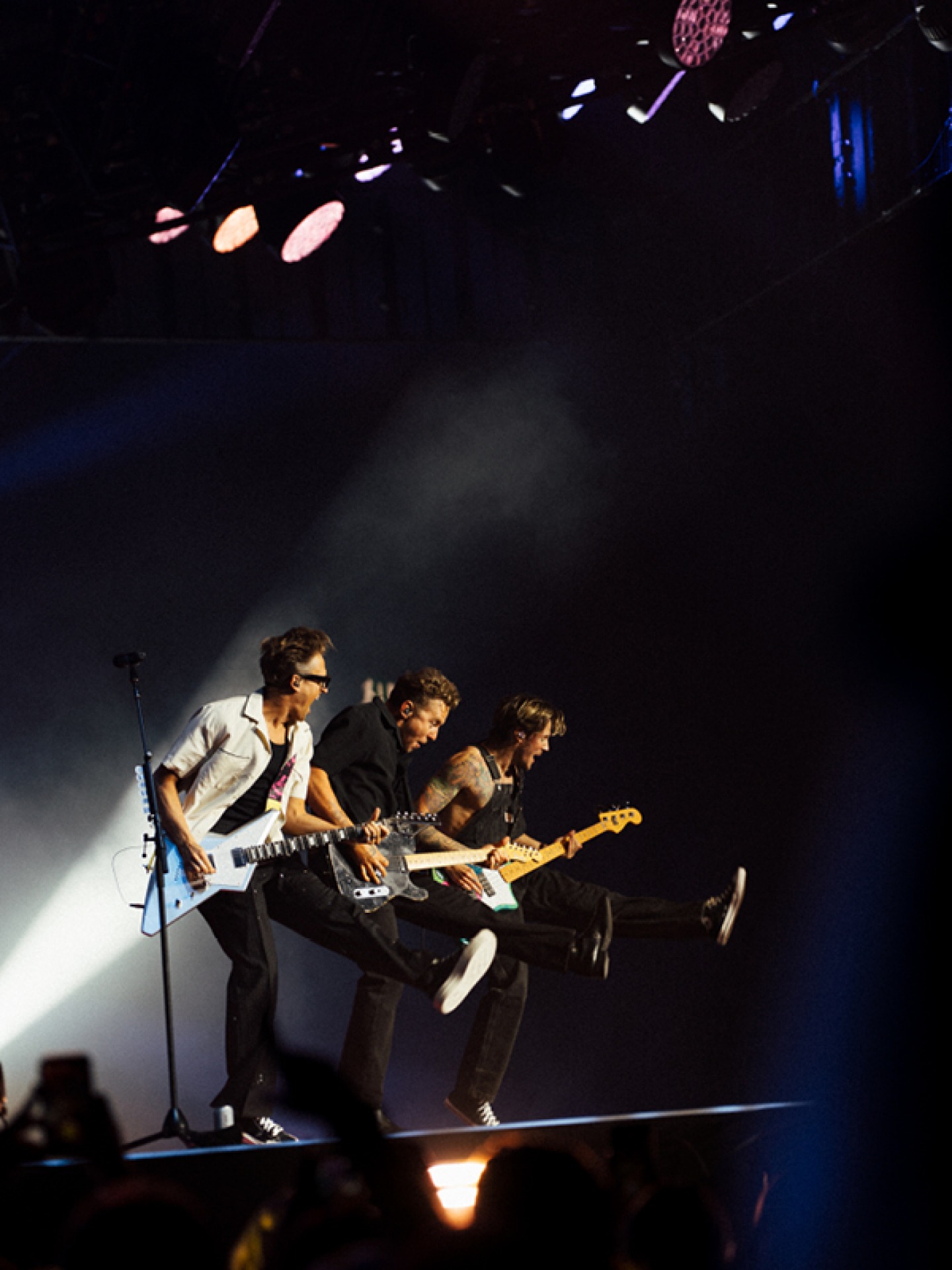Mcfly playing guitars on stage during a concert