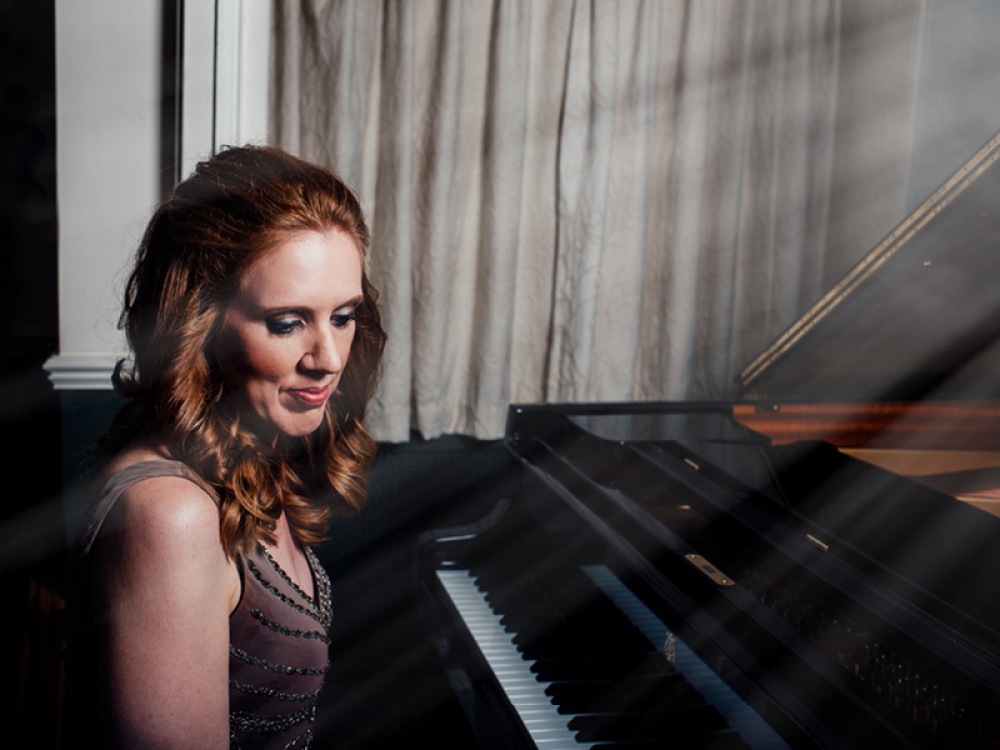 Sarah Beth Briggs sat at a piano