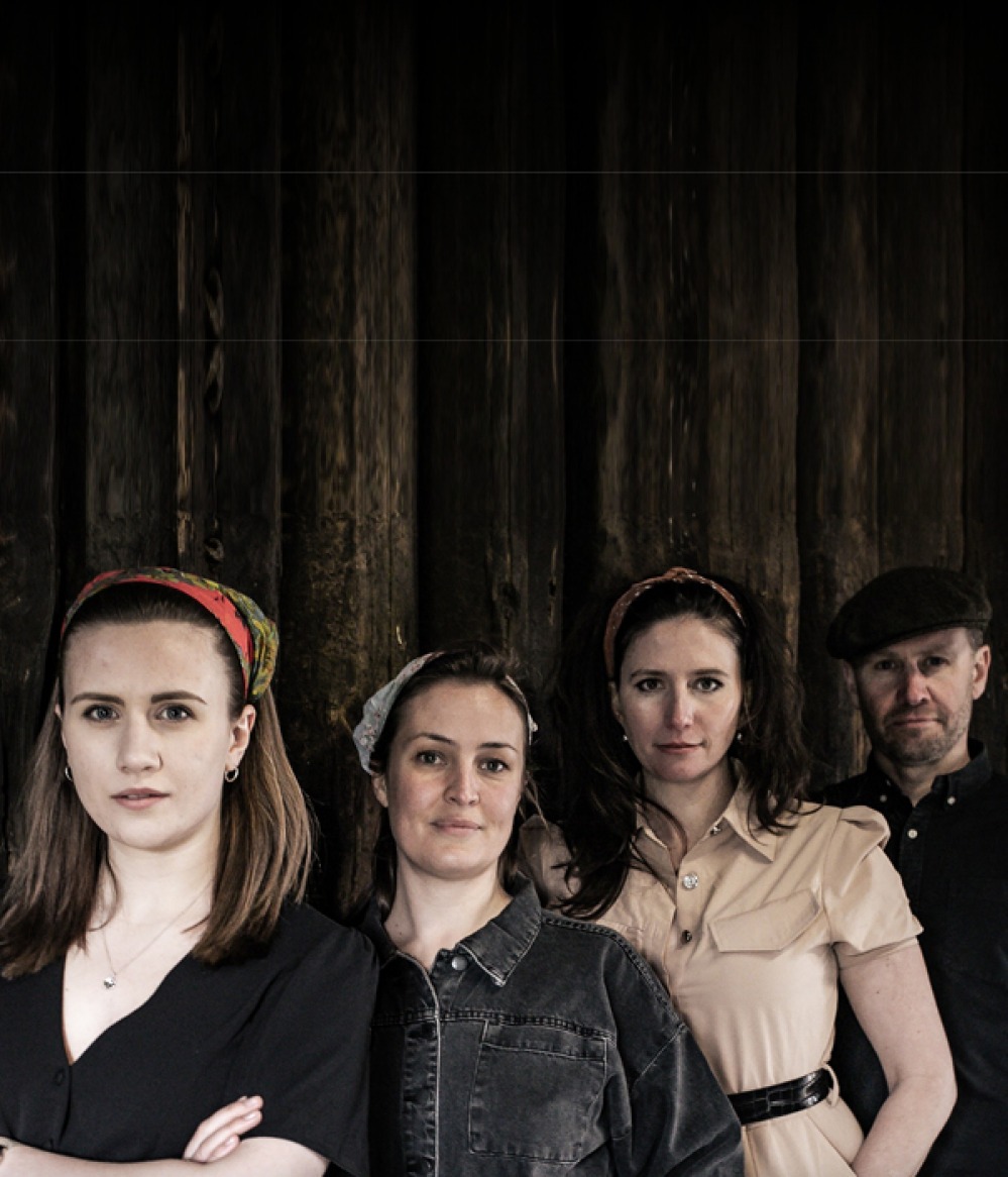Annie Ball, Katie Tertell, Bronwen Davies-Jones, Gareth Davies-Jones standing together in front of wooden wall