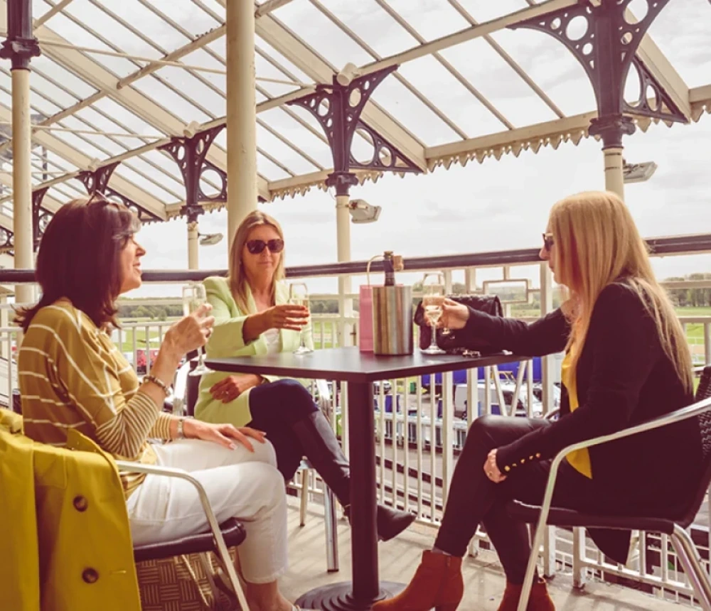 Visitor enjoying a glass of fizz on the terrace at Newcastle Race course during Living North Live 