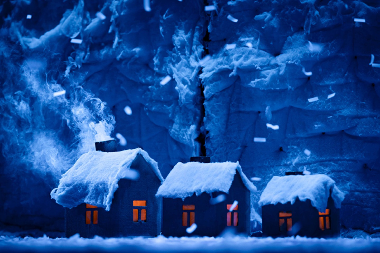 Snowy dark winter cottages on stage