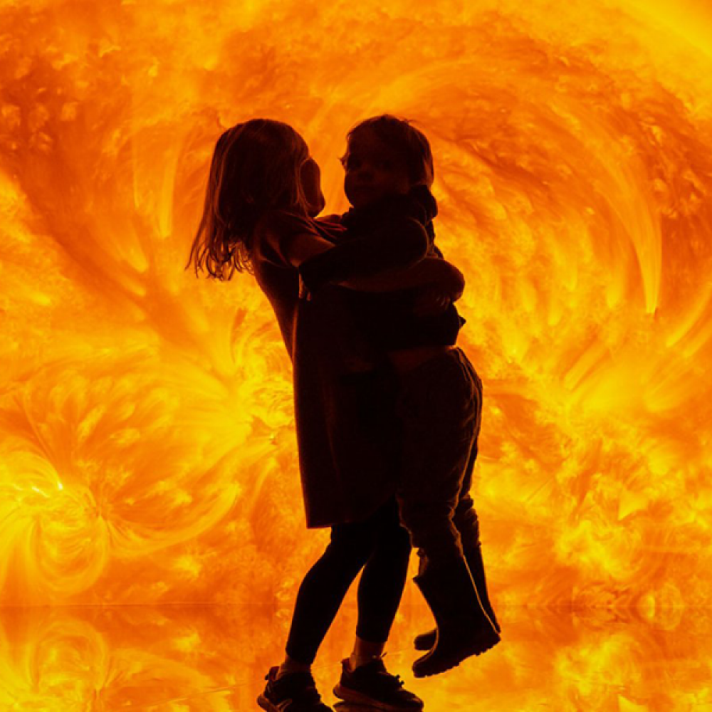 Sun exhibition with 2 young children playing