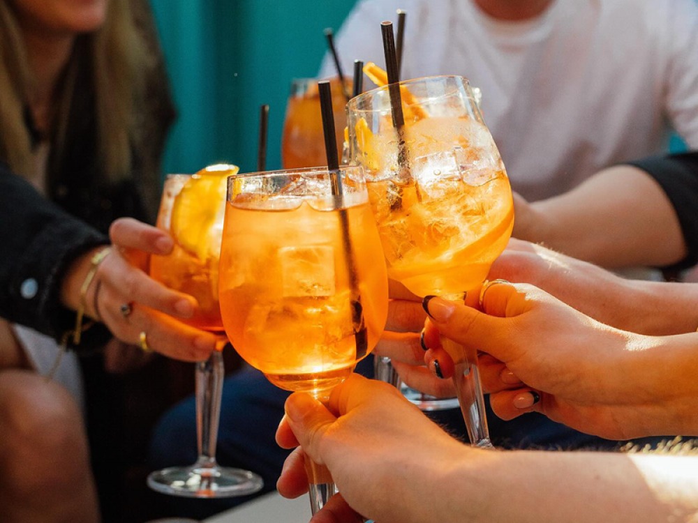 Group of friends raising glasses together at Kelu Sheffield