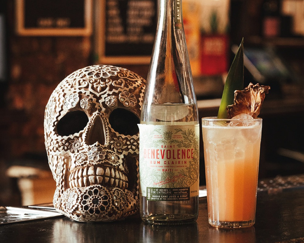 Decorative skull with glass bottle and garnished cocktail