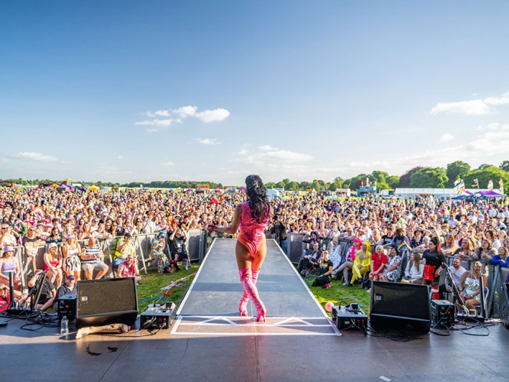Large crowd watching an artist singing on stage at York Pride