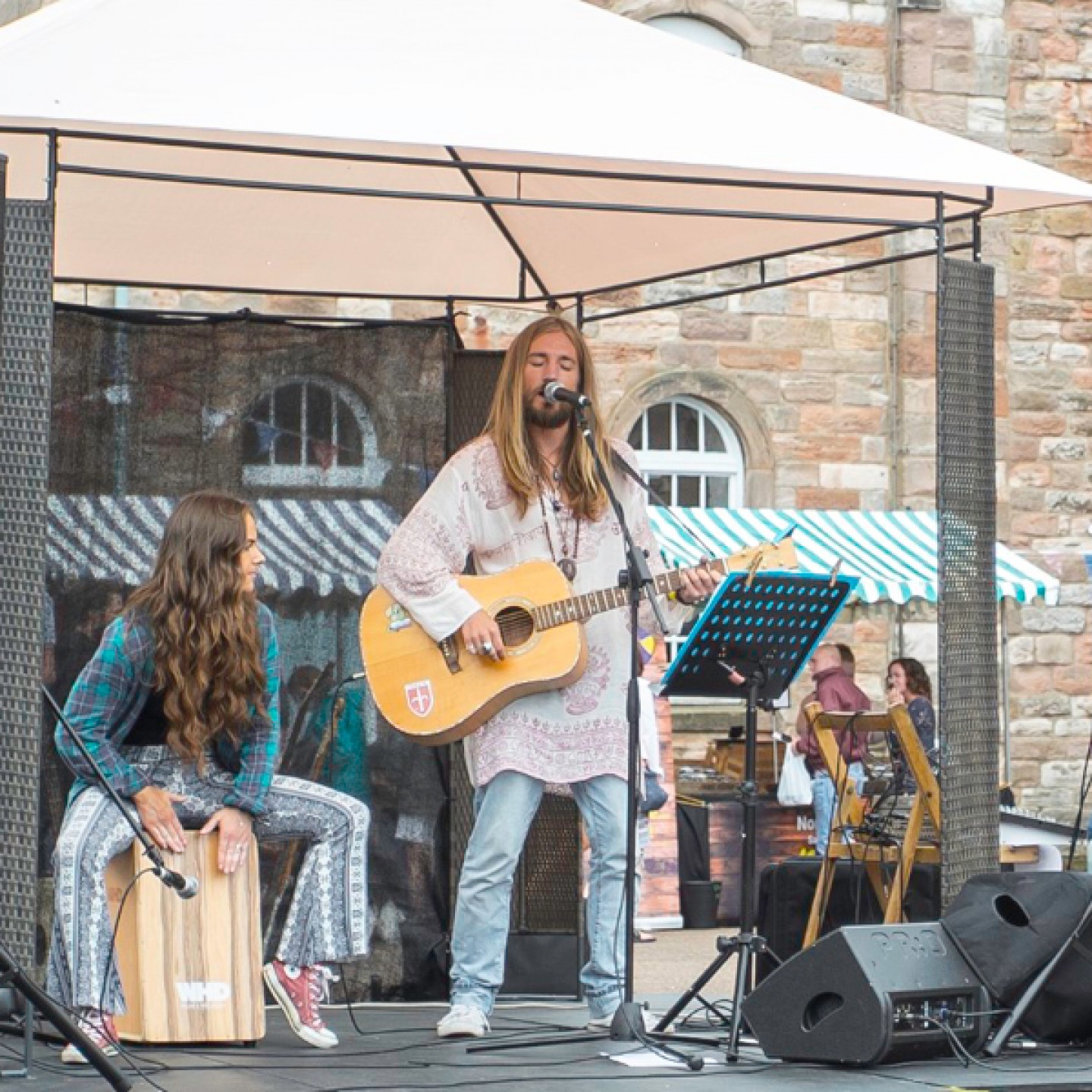 man and woman performing on stage