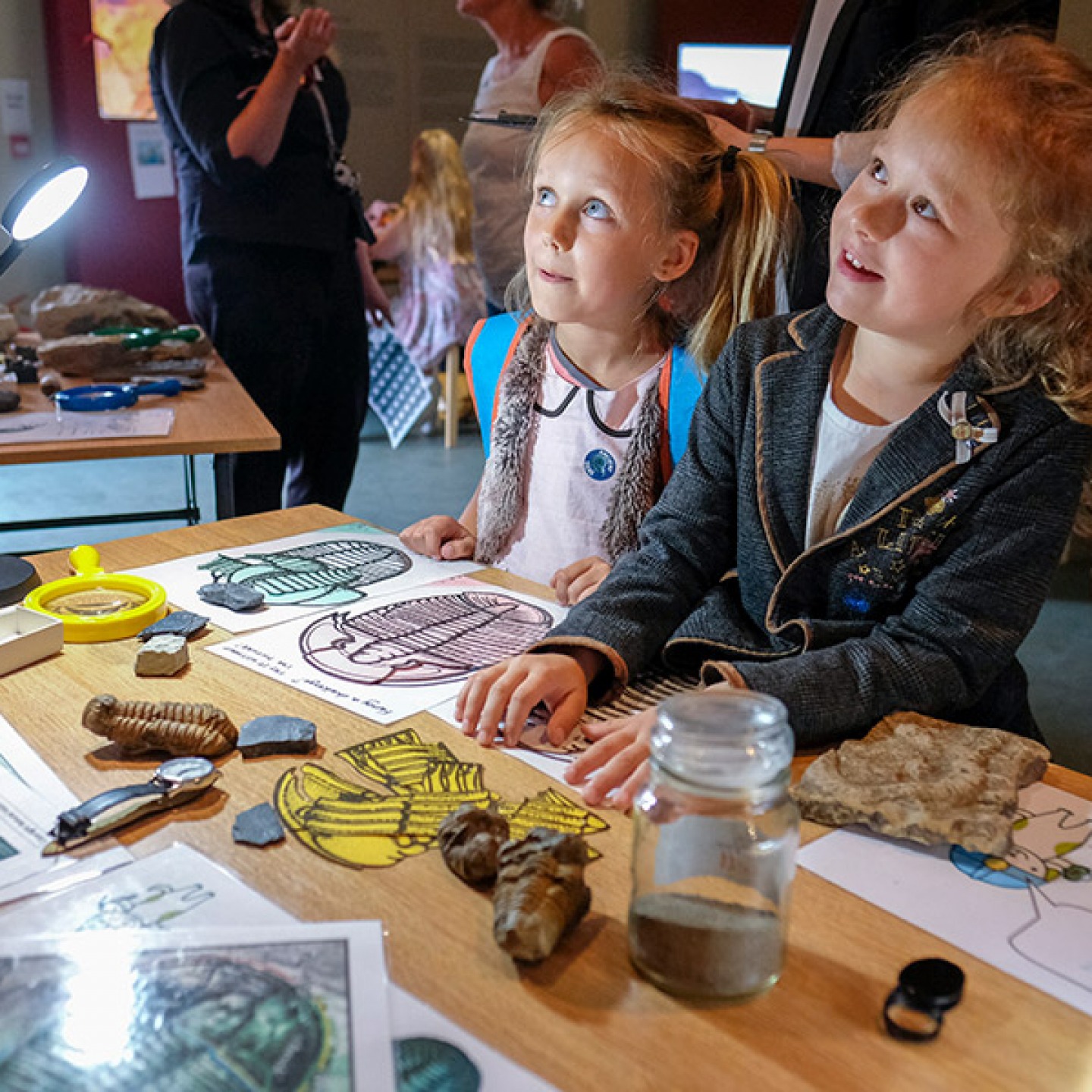 2 young girls looking at fossils