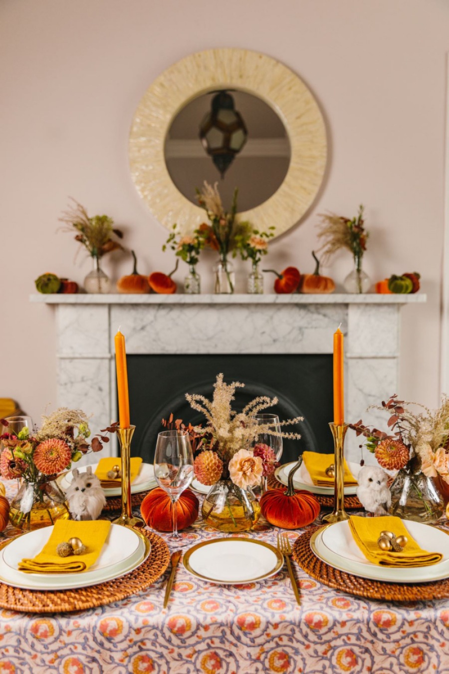 Dinner table with pumpkins, orange candles and autumnal decorations on
