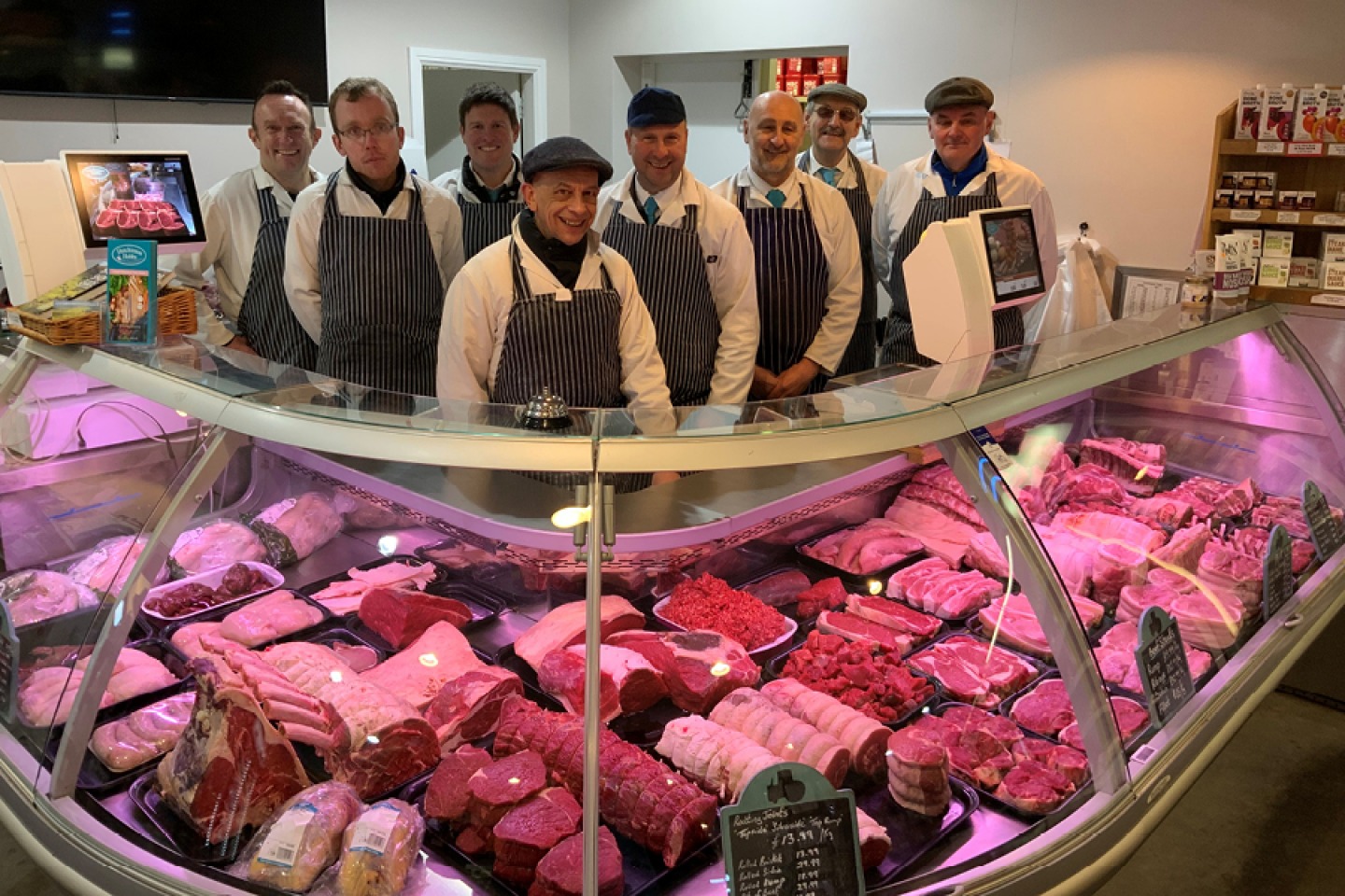 Butcher team posing for a photo at butchery counter