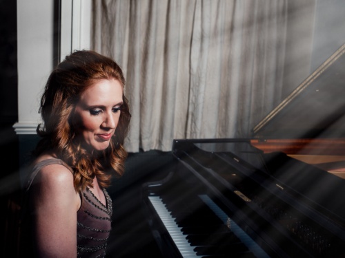 Sarah Beth Briggs sat at a piano